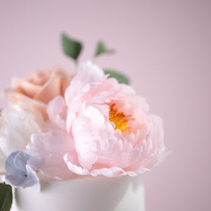 
                  
                    Load image into Gallery viewer, A close up on the pink sugar peony on the top of the cake. The peony is a lovely shade of light pink, and has a yellow middle.
                  
                