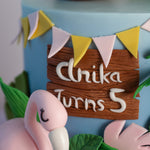 A close up to the middle of the cake. There is a fondant sign in the middle that looks like wood. 