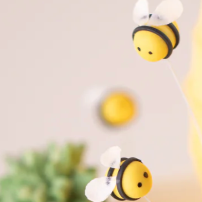 Cute little hand crafted fondant bees that have tiny translucent wings. They look straight out of a children's cartoon.