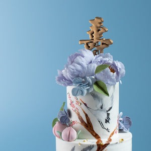 
                  
                    Load image into Gallery viewer, A close up on the top tier of the cake, with the hand painted cranes and the large sugar peonies. The peonies are lilac in colour, and the sugar hydrangeas are a shade of pale blue. 
                  
                