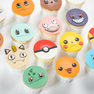 
                  
                    Load image into Gallery viewer, Cupcakes that have round fondant toppers that look like different pokemon. Three of them are types of Pokeballs. The pomemon faces are all extremely cute and true to the anime.
                  
                