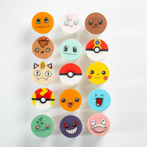 
                  
                    Load image into Gallery viewer, Cupcakes that have round fondant toppers that look like different pokemon. Three of them are types of Pokeballs. The pomemon faces are all extremely cute and true to the anime.
                  
                