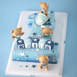 
                  
                    Load image into Gallery viewer, A large cake carved into the number &amp;quot;one&amp;quot; with an ombre blue buttercream base. There are four fondant bears on the cake, one of which is driving a light blue car. There are white and blue fondant stars in various shapes all around the cake. At the base of the &amp;quot;one&amp;quot;, there are 3D fondant alphabet blocks that spell the name &amp;quot;Kaius&amp;quot;.
                  
                